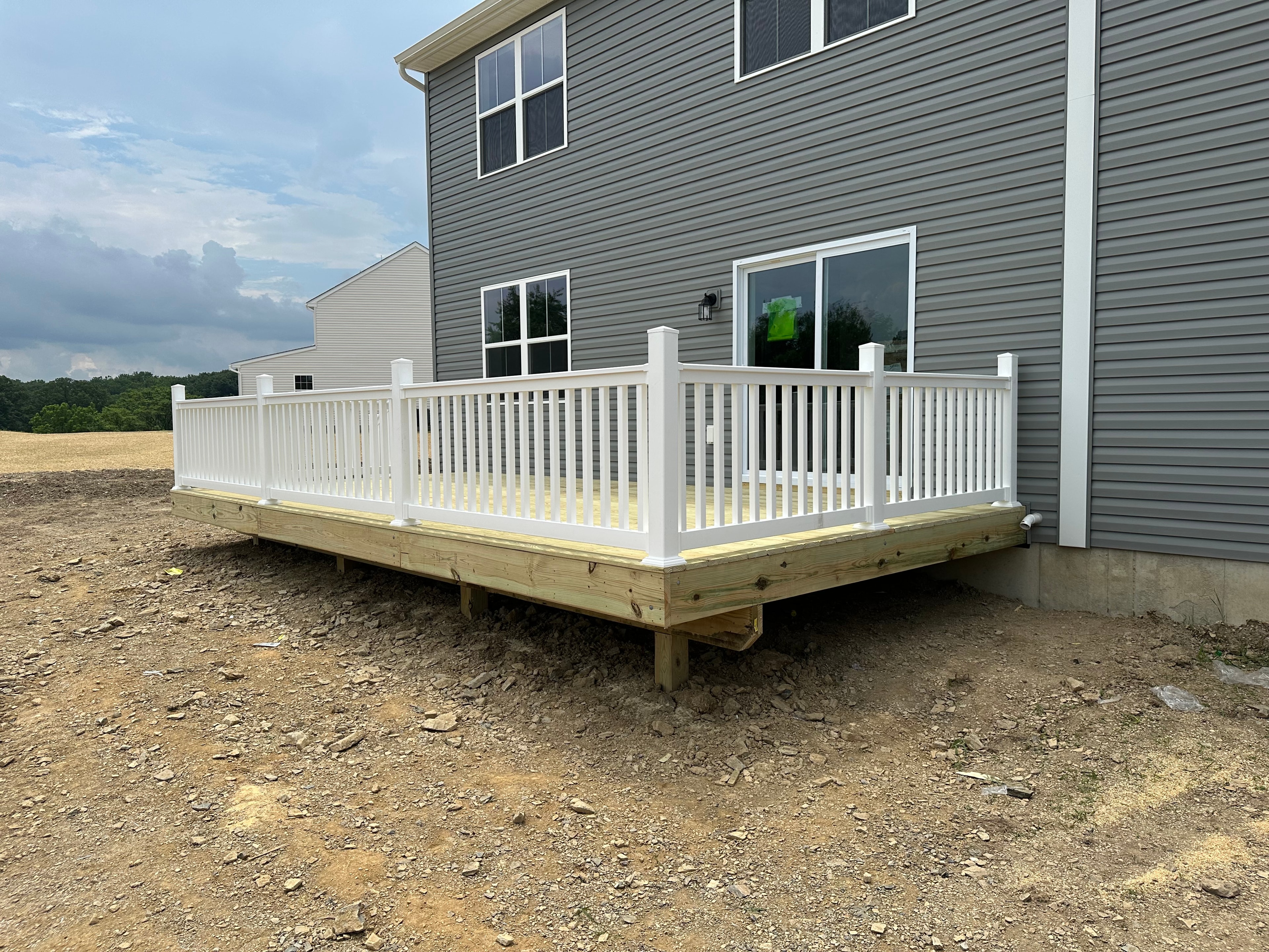 Elevated residential deck with stairs and railings